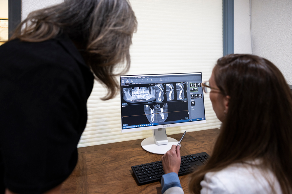Dentists analyzing digital X-rays using advanced dental imaging technology