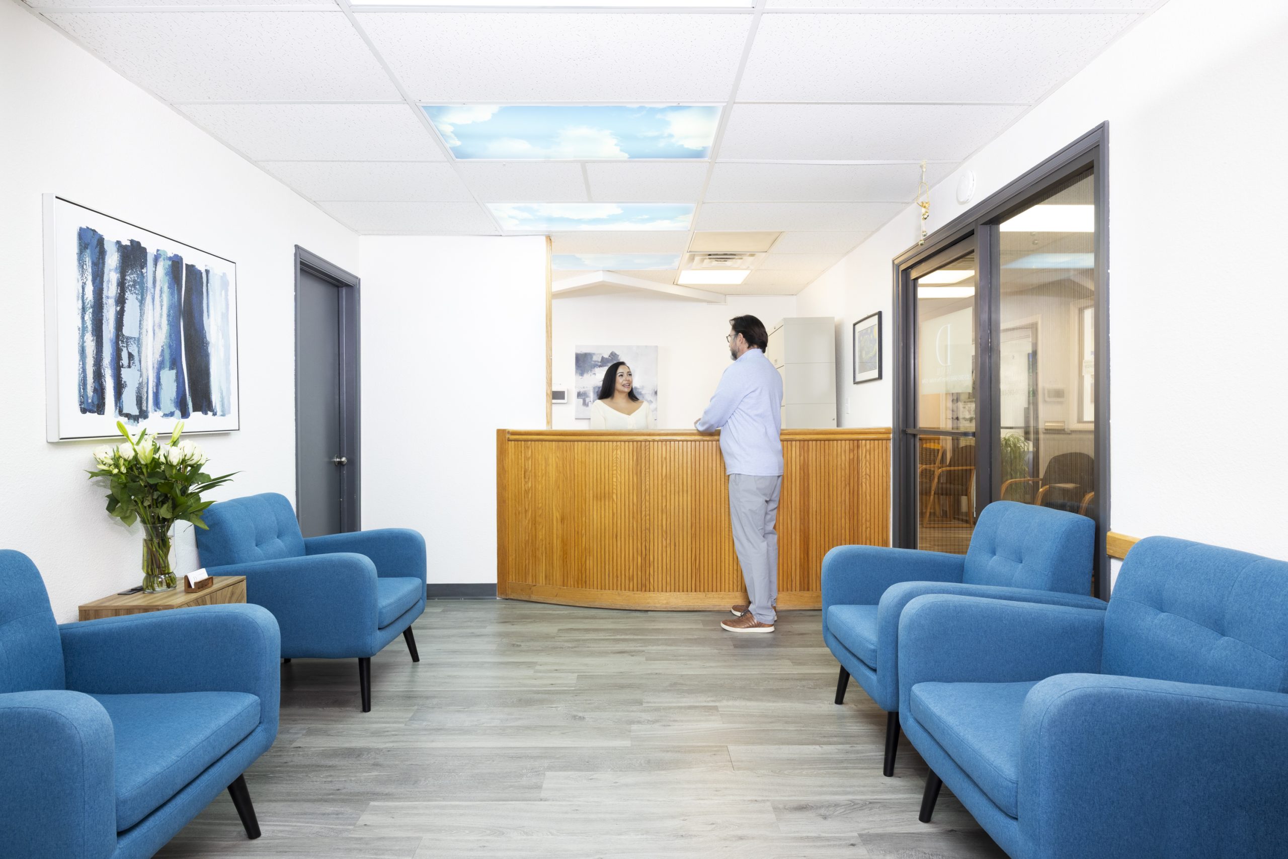 Dental office reception area with front desk and waiting space